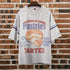 Gray t-shirt with dessert-themed design on a brick wall background